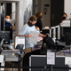 Travelers enter a new Transportation Security Administration (TSA) screening area during the opening of the Terminal 1 expansion at Los Angeles International Airport (LAX) on June 4, 2021 in Los Angeles, California.